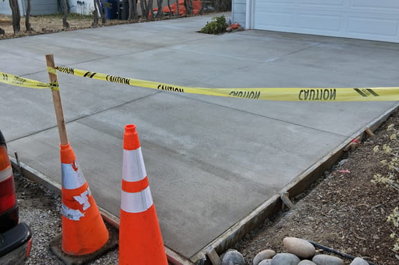 New residential concrete driveway after replacement and finishing.